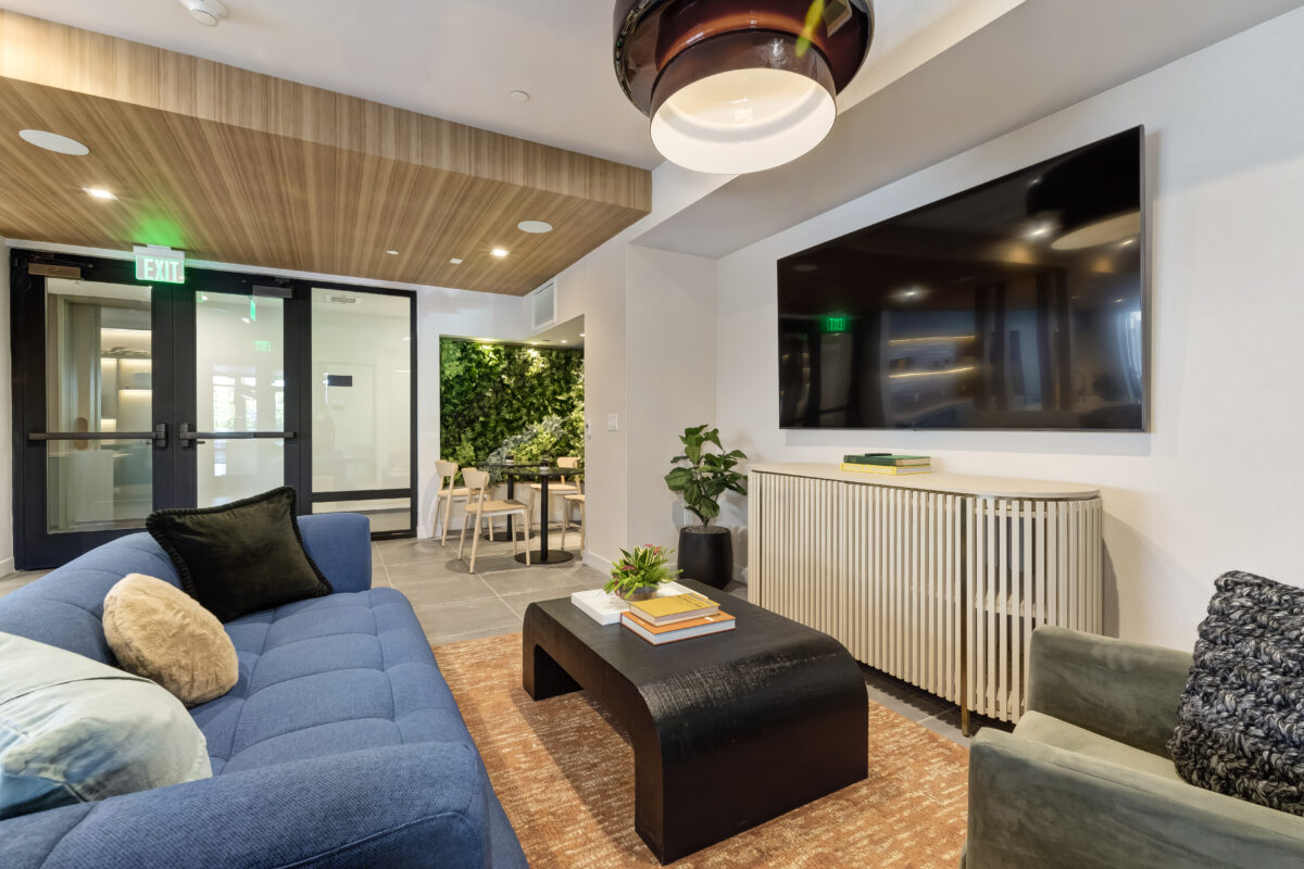 common area with a large screen and modern decor