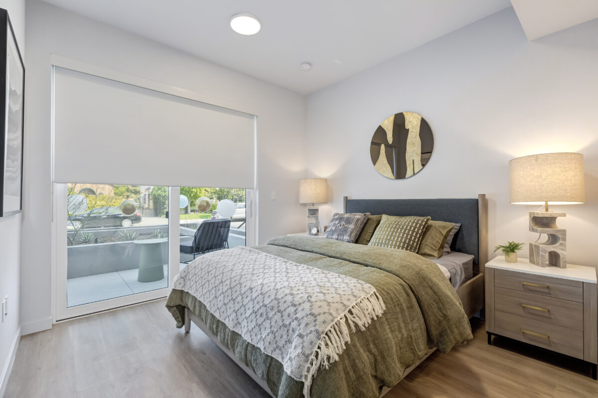 bedroom with modern decor and large glass doors