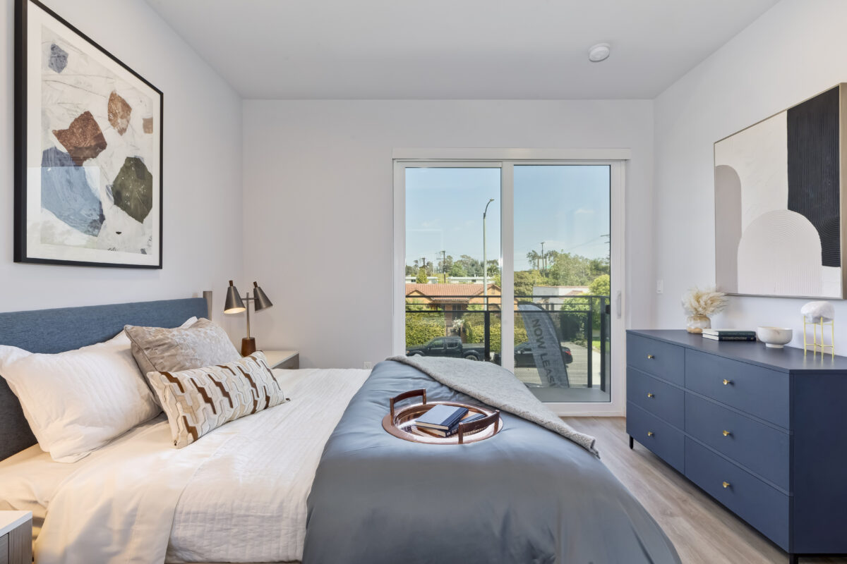 bedroom with modern decor and large glass door